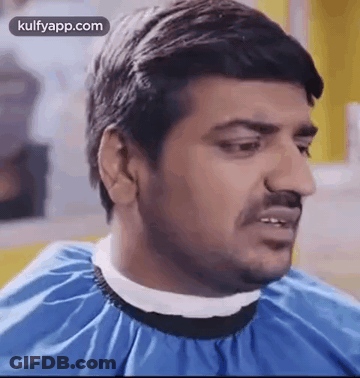 Man Getting Haircut By Barber In Blue Cape GIF