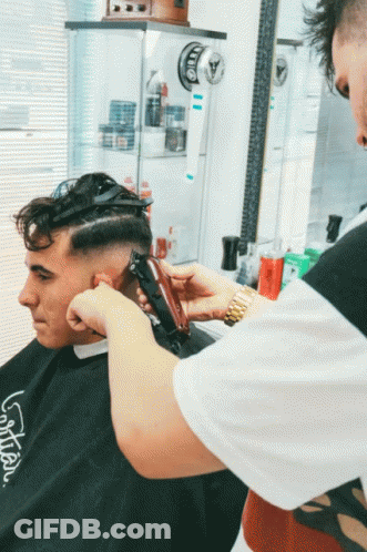 Man Getting Haircut By Barber Wearing LG Shirt GIF