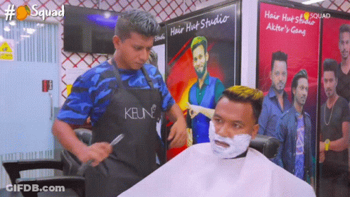 Man Getting Haircut By Man Wearing Keune Apron GIF