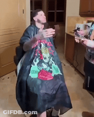 Man Getting Haircut From Skull Cape Barber GIF