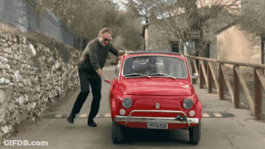 Man Getting Into A Small Fast Car GIF