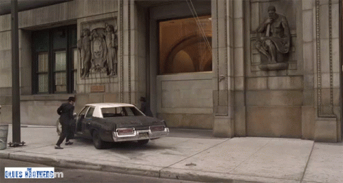 Man Getting Out Of Car With Blues Brothers Sign GIF