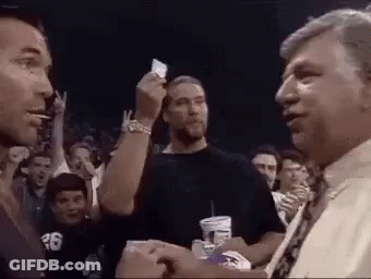 Man Giving Card To Another Man In Crowd GIF