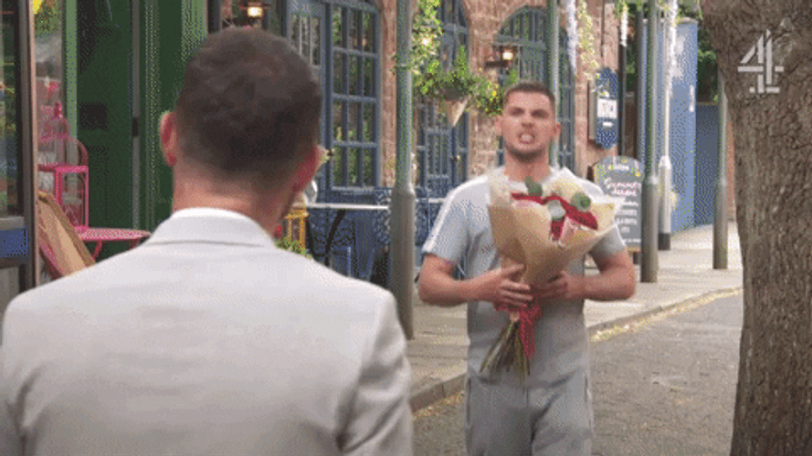 Man Giving Flowers Aggressively GIF