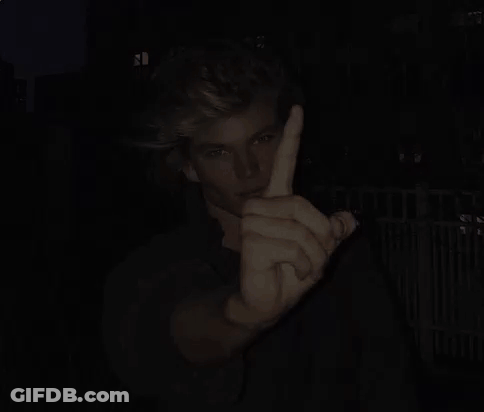 Man Giving Middle Finger In Dark GIF