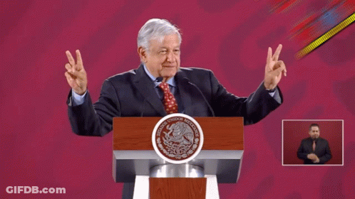 Man Giving Peace Sign At Mexico Podium GIF