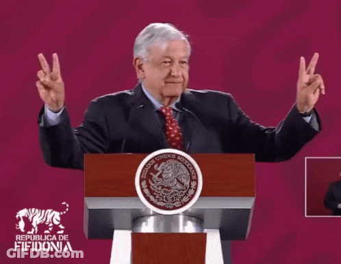 Man Giving Peace Sign At Republica De Fifidonia Podium GIF