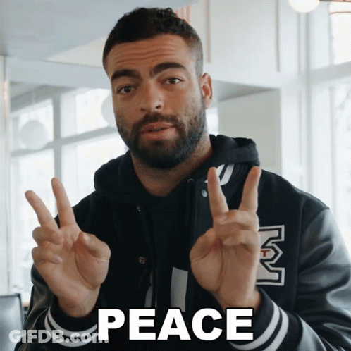 Man Giving Peace Sign Saying Peace GIF