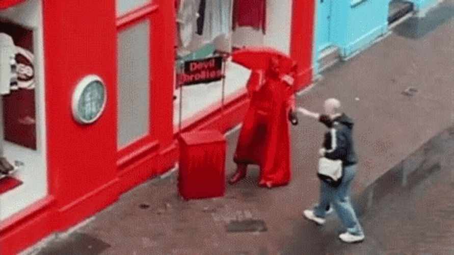 Man Giving Printed Umbrellas To People GIF
