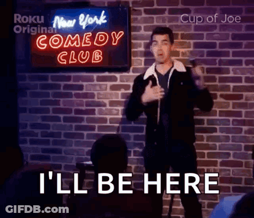 Man Giving Speech In Front Of Comedy Club Sign GIF