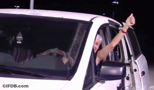 Man Giving Thumbs Up Driving White Car GIF