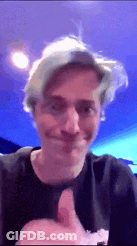 Man Giving Thumbs Up In Front Of Blue Background GIF