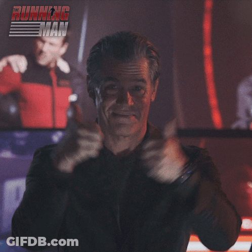Man Giving Thumbs Up In Front Of Running Man Sign GIF