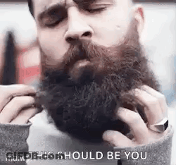 Man Grooming Beard With Comb GIF