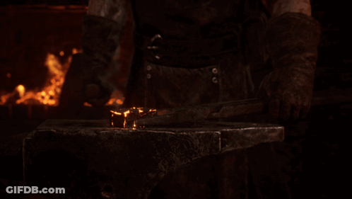 Man Hammering Metal On Anvil GIF