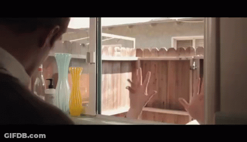 Man Hands On Window Looking At Fence GIF