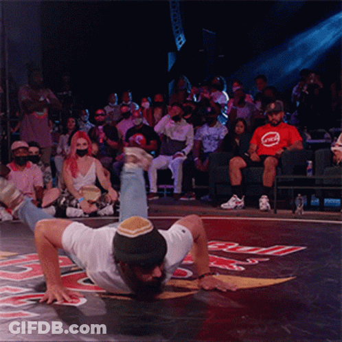 Man Handstanding Before Crowd In Red Bull Shirt GIF