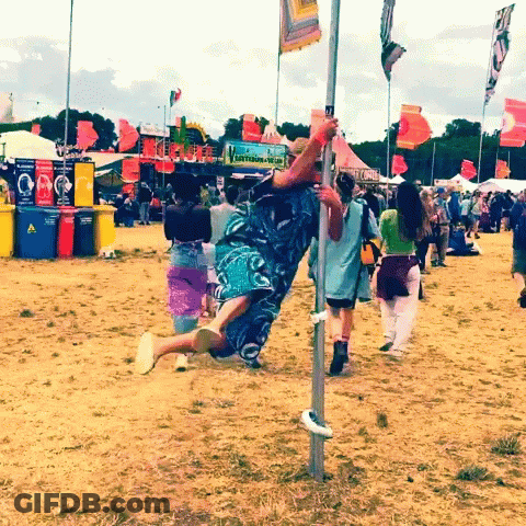 Man Hanging Upside Down Near Recycling Sign GIF