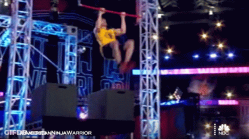 Man Hanging Upside Down On Bar In NBC Advertisement GIF