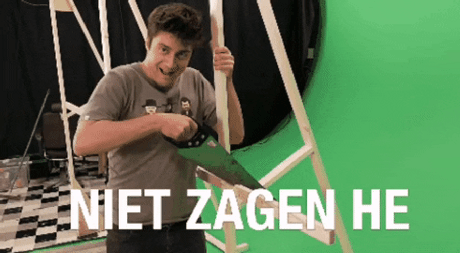 Man Happily Holding Hand Saw Inside Studio GIF