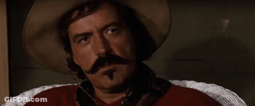 Man Hat Mustache Says Bye In Wicker Chair GIF