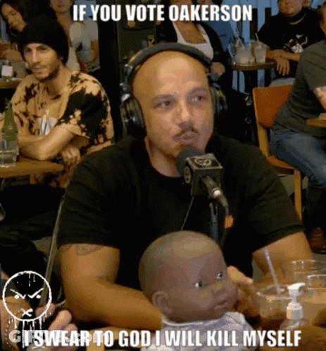 Man Headphones Holding Baby Doll Says If You Vote Oakerson GIF