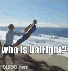Man Holding Another Man On Beach Saying Who Is Balright GIF