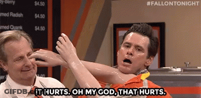 Man Holding Another Man's Arm Saying It Hurts GIF