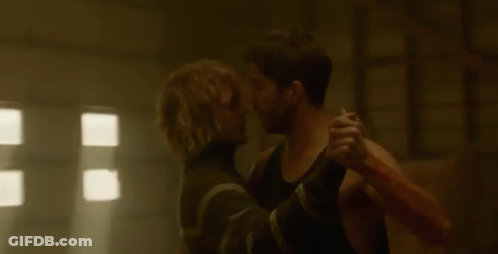 Man Holding Another Man While Dancing In Dark Room GIF