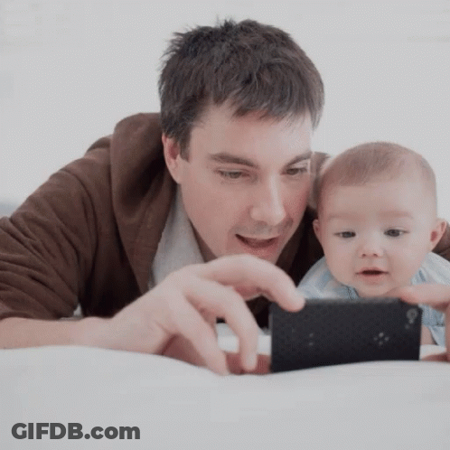 Man Holding Baby And Cell Phone GIF