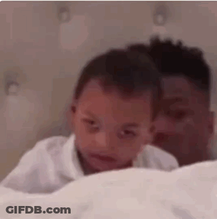 Man Holding Baby Laying On Bed GIF