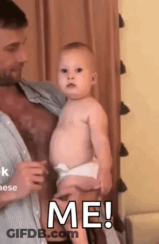 Man Holding Baby Saying Me GIF