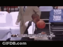 Man Holding Basketball In Front Of MGM Logo GIF