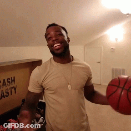 Man Holding Basketball Next To Cash Asty Box GIF