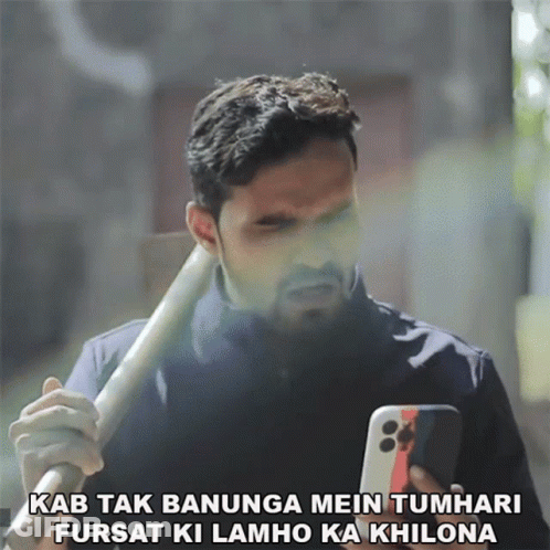 Man Holding Bat Looking At Phone Kab Tak Banunga Mein Tumhari GIF