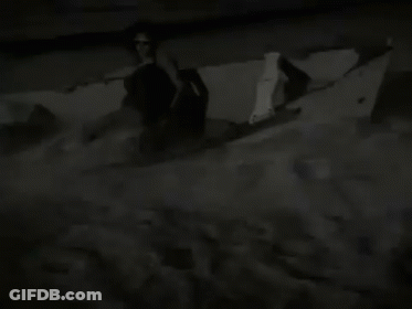 Man Holding Blue Balloon In Front Of Speeds & Scooters Sign GIF