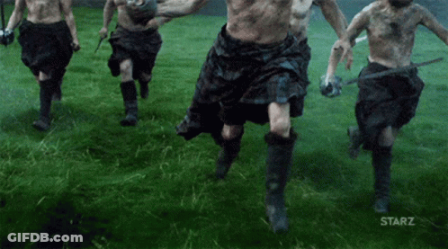Man Holding Blue Flag With Letter G Walking GIF