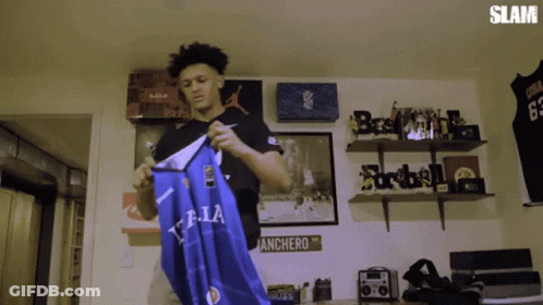 Man Holding Blue T.LA Shirt GIF