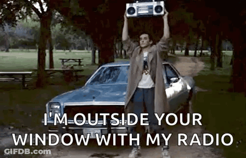 Man Holding Boombox Over Head In Park GIF