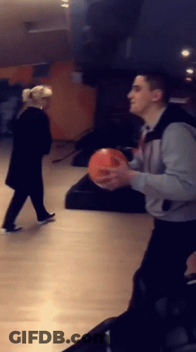 Man Holding Bowling Ball Woman Looking On GIF