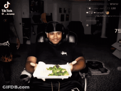 Man Holding Broccoli In Front Of TikTok Screen GIF