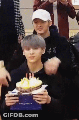 Man Holding Cake With Candles Another Man Watching GIF