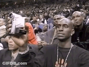 Man Holding Camera In Front Of Crowd GIF