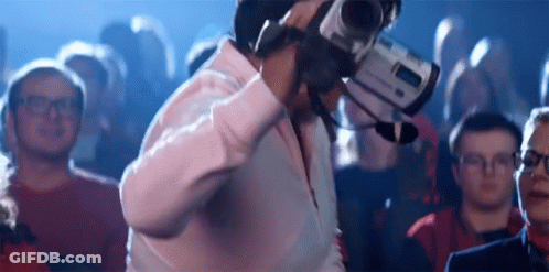 Man Holding Camera In Front Of Crowd GIF