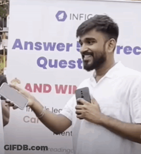Man Holding Cell Phone In Front Of Answer Quest Sign GIF
