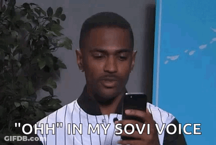 Man Holding Cell Phone Saying Ohh In Sovi Voice GIF