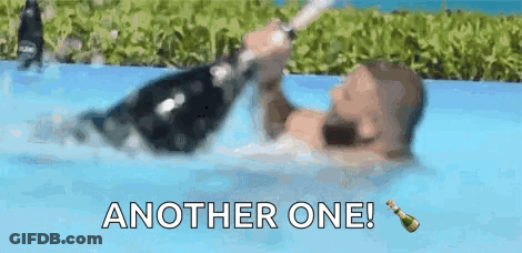 Man Holding Champagne Bottle In Pool GIF