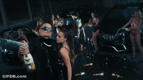 Man Holding Champagne In Front Of Woman GIF