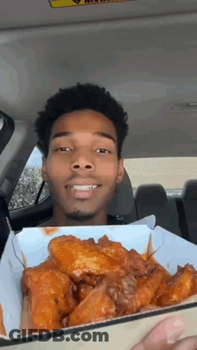 Man Holding Chicken Wings And Smiling GIF
