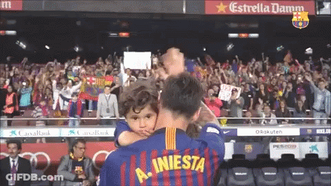 Man Holding Child In Iniesta Jersey GIF